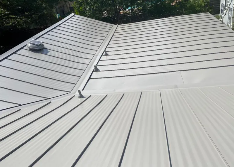 Solar attic fan installed on a metal roof for Roof Ventilation in Pahokee